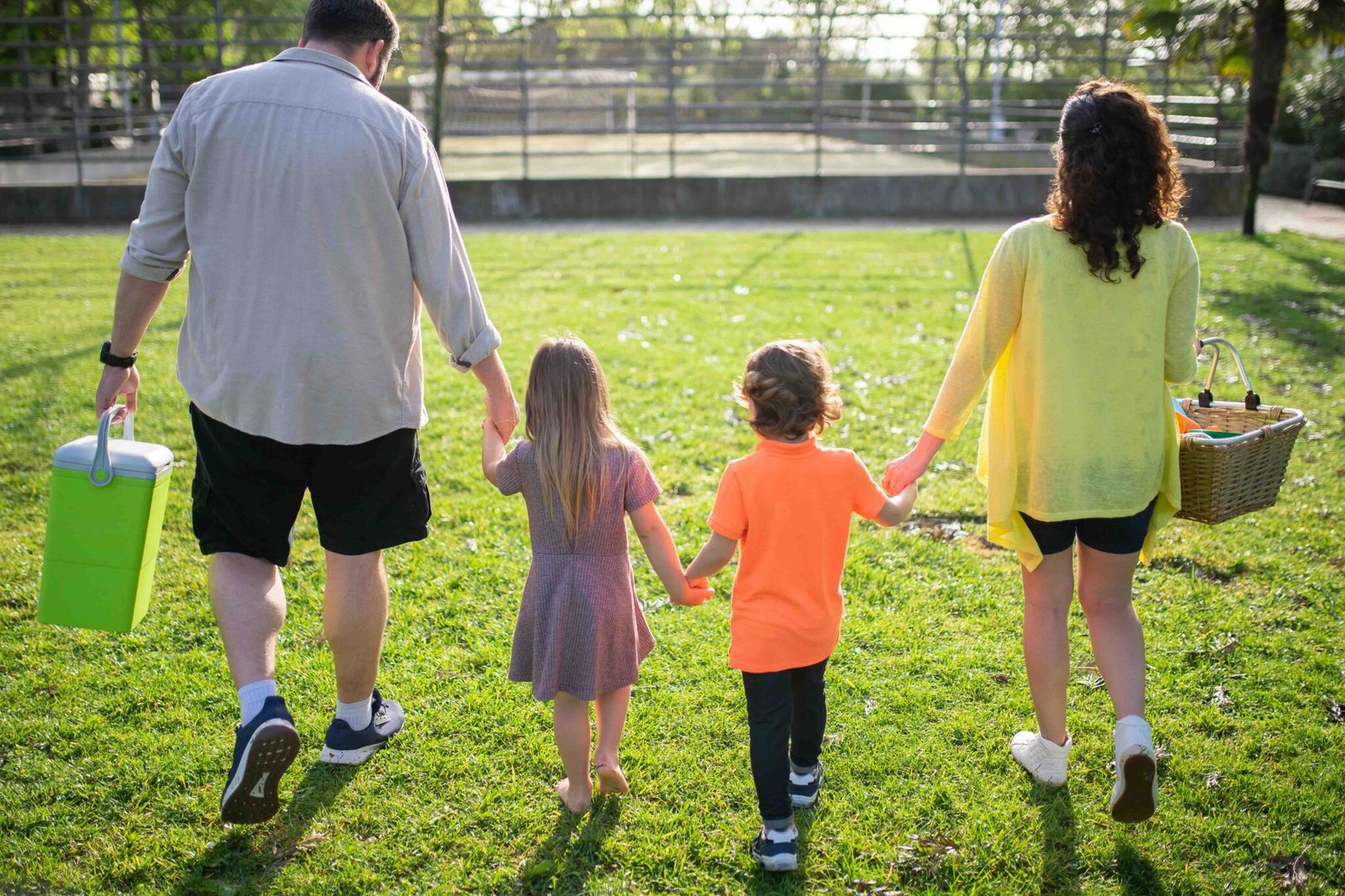 A-Family-Walking-on-a-Grassy-Field