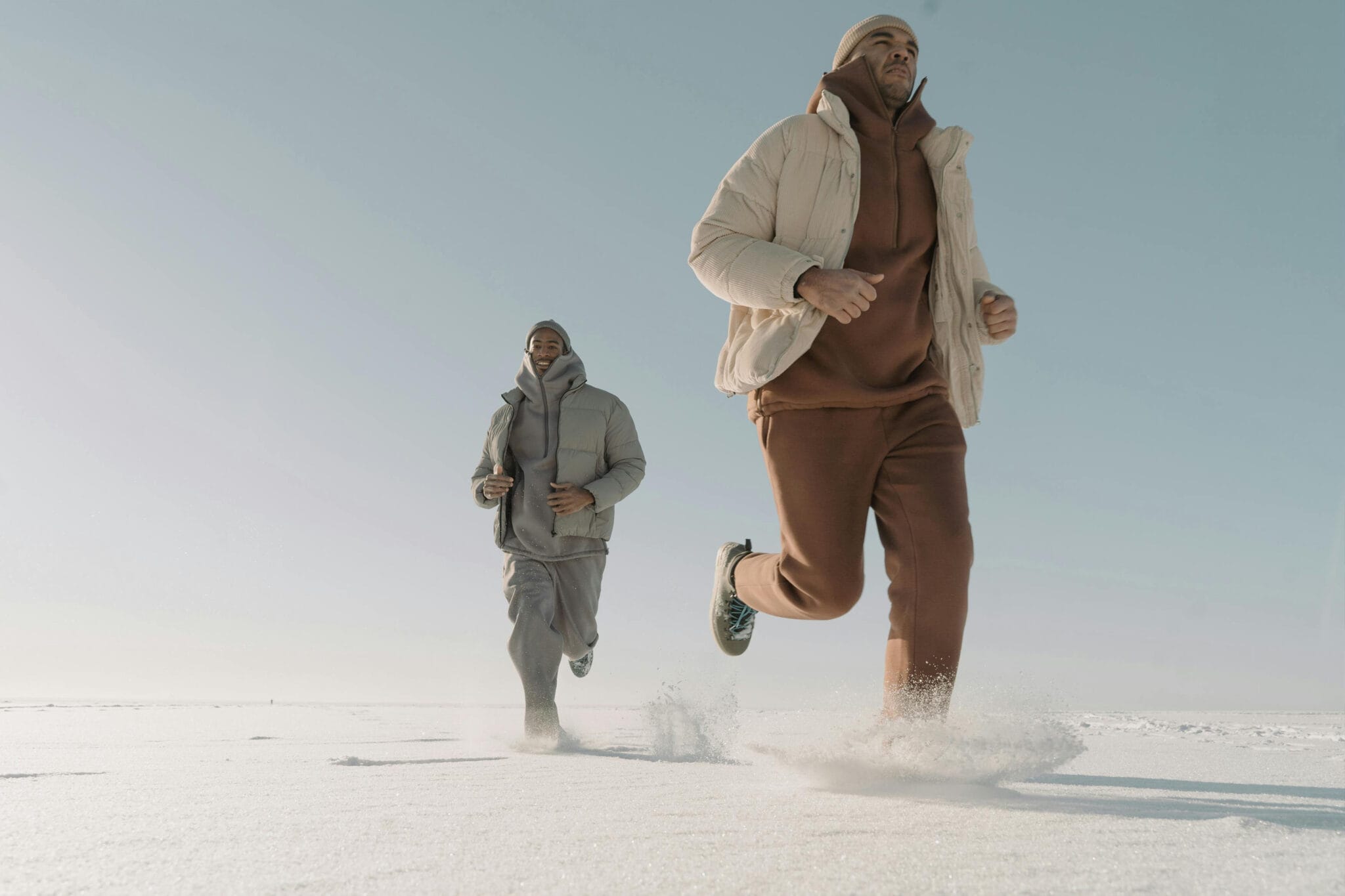 Ultimate Guide to Wellness Pods: Benefits, Types & Uses 10 photo-of-two-mans-wearing-puffer-jackets-running-on-thick-snow