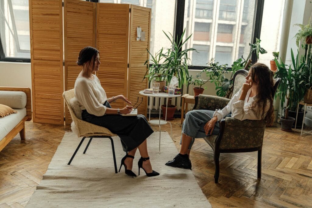 TMS Therapy Reviews: Insights from Real Patients 1 photo woman in white shirt sitting on chair