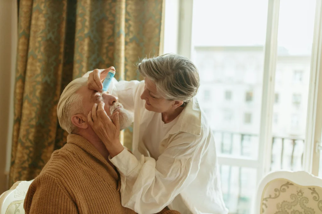 How Advanced Vision Wellness Centers Enhance Eye Health 5 phot-of-elderly-woman-putting-eyedrops-into-the-eyes-of-an-elderly-man-