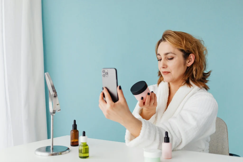 The Ultimate Review of Love Wellness: Health Products 7 photo-of-a-woman-in-white-robe-sitting-while-holding-her-phone-