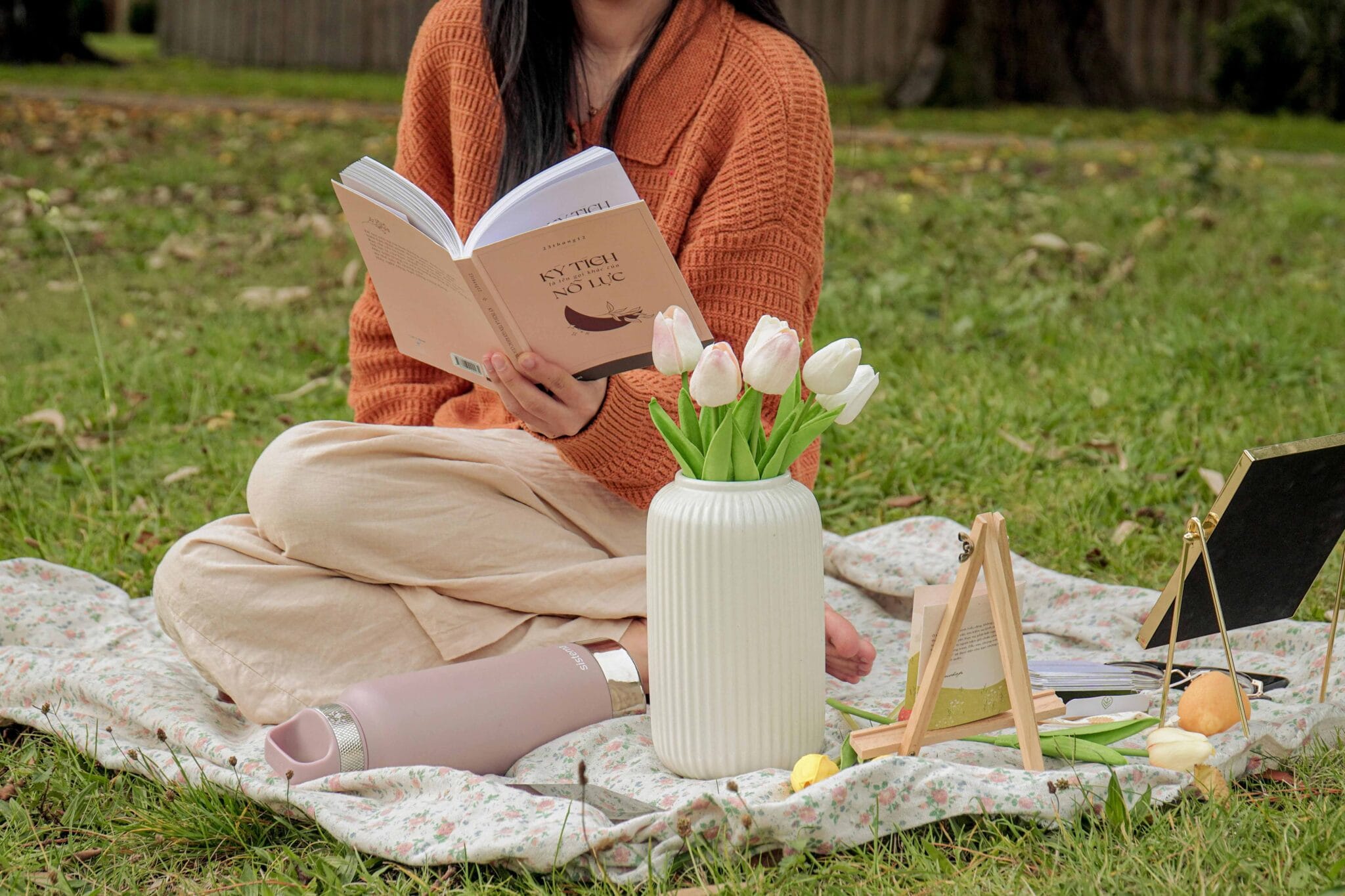 The Holistic Guide to Wellness Review 2 photo-of-a-woman-reading-a-book-near-a-vase-with-tulips-