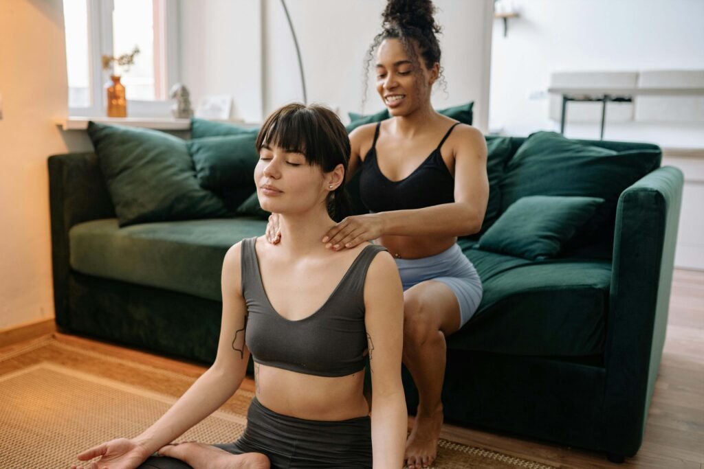 Guide to Holistic Wellness Massage 7 photo-of-woman-in-black-tank-top-and-black-and-white-striped-skirt-sitting-on-couch